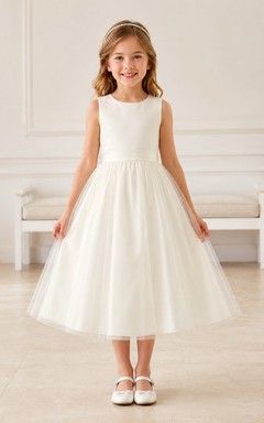 Vestido de niña de flores sin mangas de tul color marfil con corte en A, escote joya y falda a la altura de la rodilla con detalle de lazo.