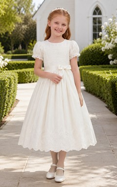 Robe de première communion en dentelle, col rond, manches bouffantes et longueur thé