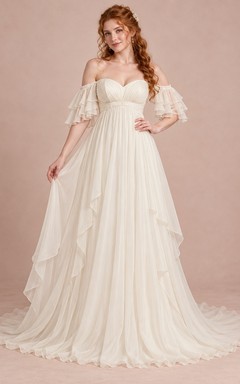 Vestido de novia largo estilo imperio con escote corazón, mangas superpuestas, gasa fruncida y caída en cascada.