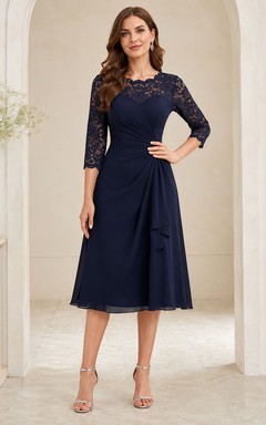 Vestido de maternidad Nocturne azul marino oscuro con escote barco, mangas acampanadas, encaje y gasa, corte en A, largo hasta la rodilla, efecto ilusión.