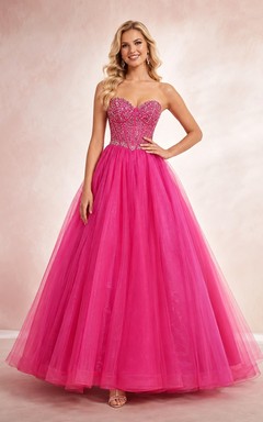 Vestido de fiesta/quinceañera de lujo en tul fucsia de un solo hombro, escote corazón y lentejuelas.