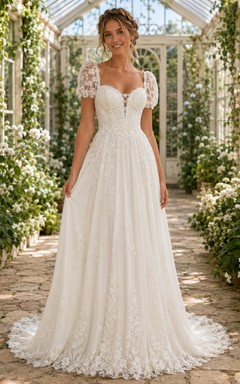Robe de mariée romantique longue jusqu'au sol, décolleté cœur, manches bouffantes, en dentelle, idéale pour une réception champêtre.