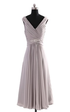 Vestido de gasa sin mangas con escote en V y corte imperio con volantes.