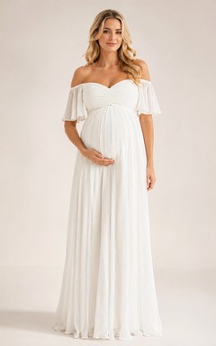 Robe de mariée de maternité style empire, longue jusqu'au sol, épaules dénudées, manches courtes, en mousseline, romantique et élégante, idéale pour un jardin.