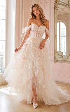 Vestido de novia romántico blanco de tul con volantes, manga corta, hombros descubiertos y corte en A, estilo asimétrico.