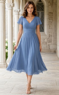 Robe mi-longue en mousseline bleu acier, col en V, manches papillon, coupe trapèze, longueur thé