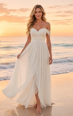 Robe de mariée trapèze en mousseline à épaules dénudées et décolleté cœur, idéale pour une cérémonie de renouvellement de vœux à la plage.