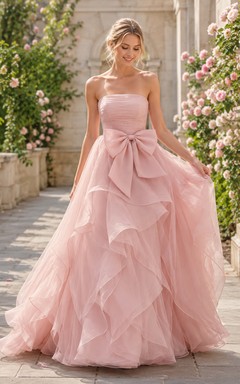 Robe de mariée bustier rose poudré à volants en tulle et nœud cascade