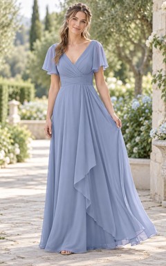 Vestido de dama de honor largo hasta el suelo, romántico, de gasa color bígaro con mangas cruzadas y volantes en cascada.