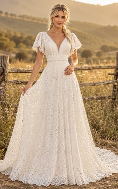 Robe de mariée champêtre en tulle, coupe trapèze, col en V, manches papillon, traîne chapelle, dos nu plongeant.
