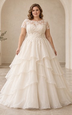 Vestido de novia modesto de encaje con escote redondo, mangas cortas y capas de tul en cascada.