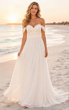 Vestido de novia de gasa con escote Bardot y cola larga, ideal para fugarse a la playa.