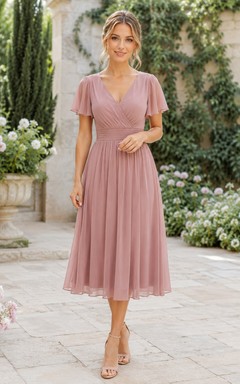Robe trapèze en mousseline rose poudré à col en V et longueur thé