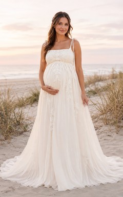 Robe de mariée en tulle style empire, épaules dénudées, longueur au sol, idéale pour la plage.