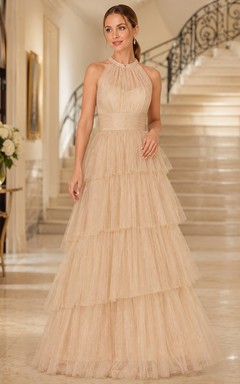 Vestido de gala color champán con cuello alto, mangas cortas y volantes escalonados