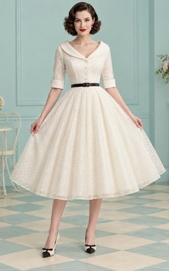 Robe de mariée trapèze mi-longue à pois suisses style rockabilly, col portrait et ceinture noire