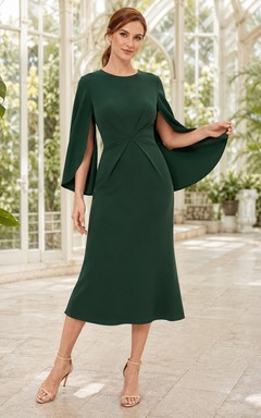 Robe de bal midi en crêpe vert forêt, col bateau rond, manches cape, taille cintrée et coupe fourreau longueur thé