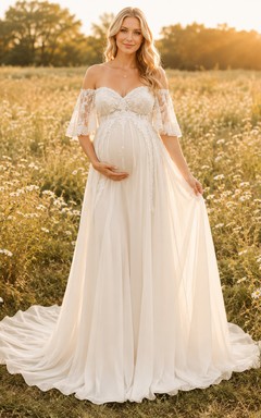 Vestido de novia premamá con escote corazón, mangas de encaje y corte en A con cola.