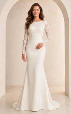 Elegante vestido de novia de corte sirena con escote barco, mangas largas y encaje ilusión.