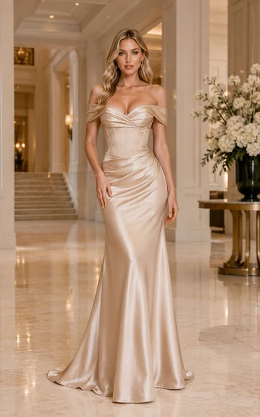 Vestido formal de satén color champán con escote Bardot, corte sirena, corpiño tipo corsé y falda fruncida.