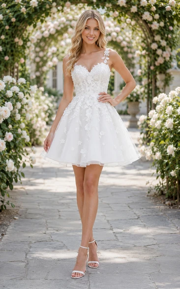 Vestido de novia corto de corte A con tirantes ilusión de apliques florales.