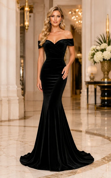 Vestido formal de terciopelo negro estilo sirena con hombros descubiertos, escote corazón y cola larga.