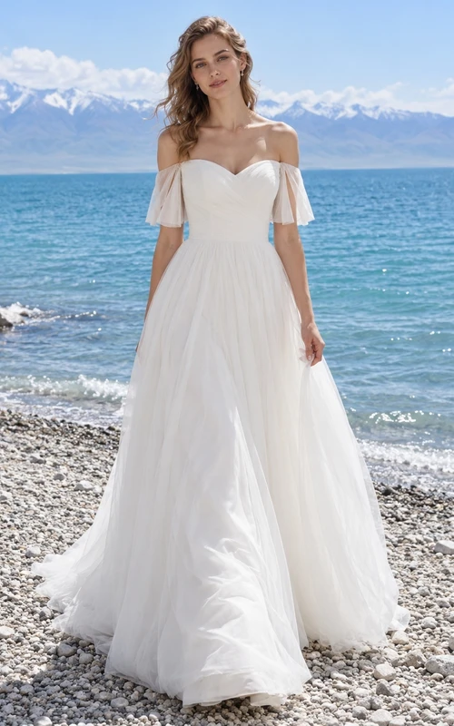 Vestido de novia sencillo de tul con escote corazón, mangas con volantes y hombros descubiertos