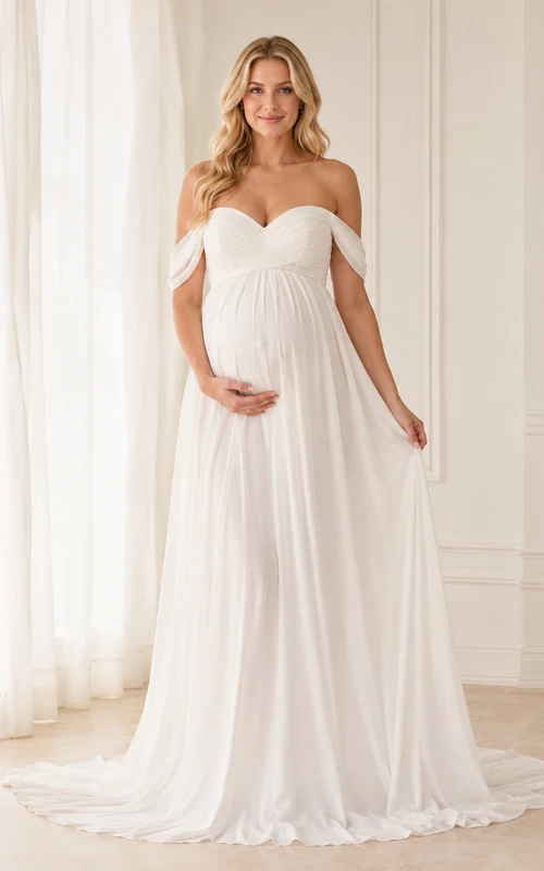 Vestido de maternidad romántico blanco de gasa con escote corazón, hombros descubiertos y corte imperio con cola.