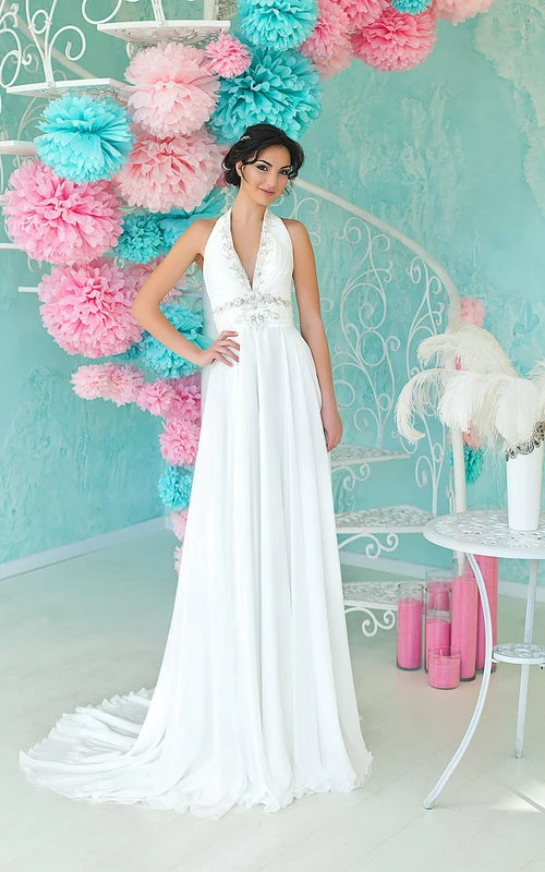Vestido de gasa sin mangas, con escote halter y espalda descubierta, corte imperio, largo hasta el suelo, con abalorios y fruncido.