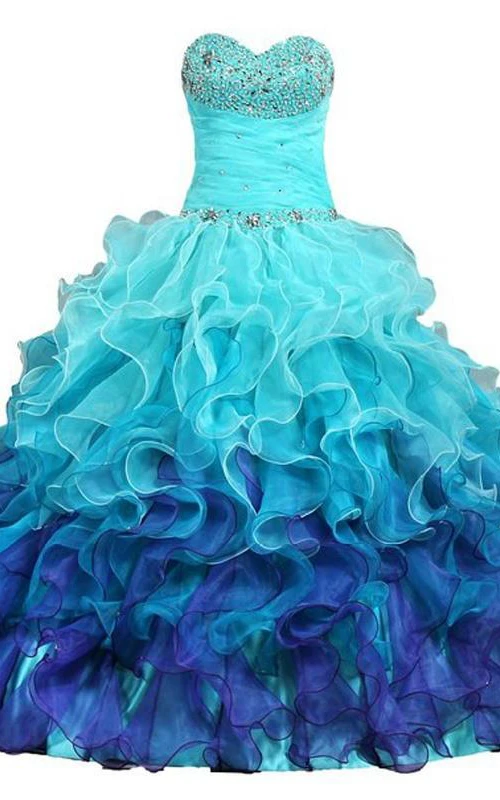 Robe de bal longue à décolleté cœur sans manches, ornée de perles et de volants cascade, dos lacé, en dentelle et sequins. Robe en organza.
