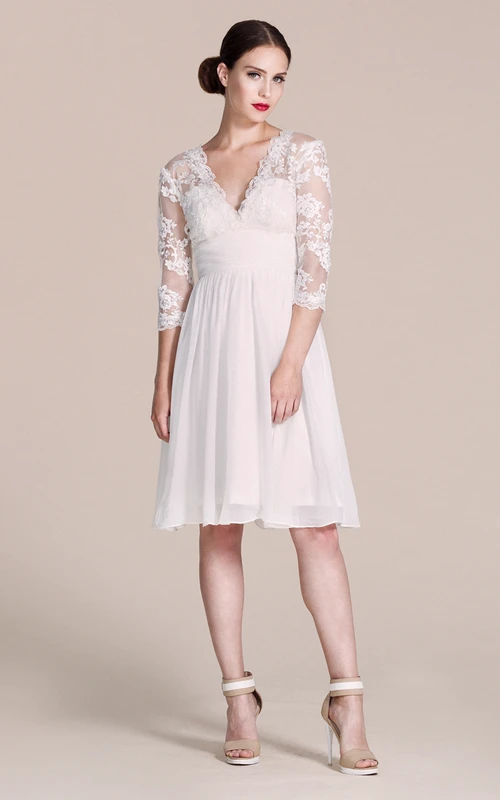 Vestido de manga 3-4 con escote en V y largo hasta la rodilla con encaje.