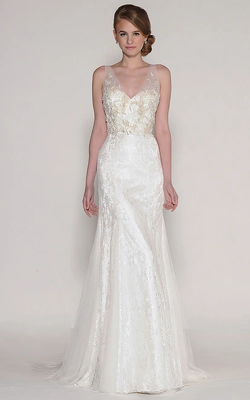 Vestido de novia de tul sin mangas, largo hasta el suelo, con escote en V, apliques y pedrería.