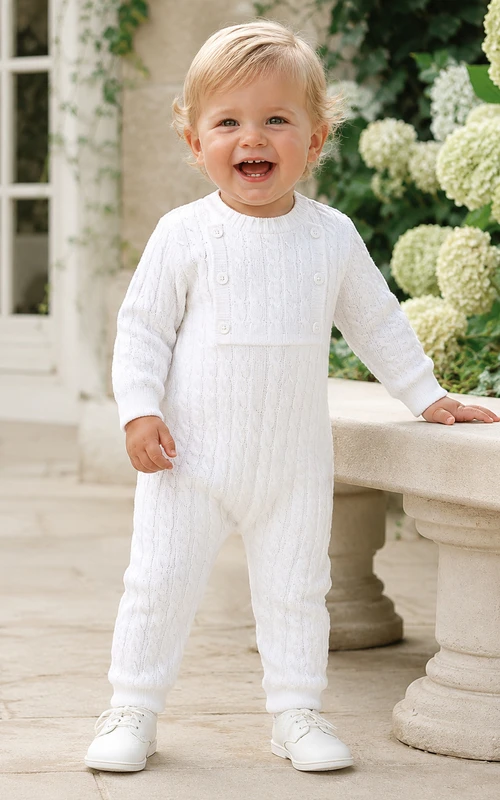 Pelele de bautizo blanco de punto trenzado con canesú abotonado y manga larga para bebé niño.