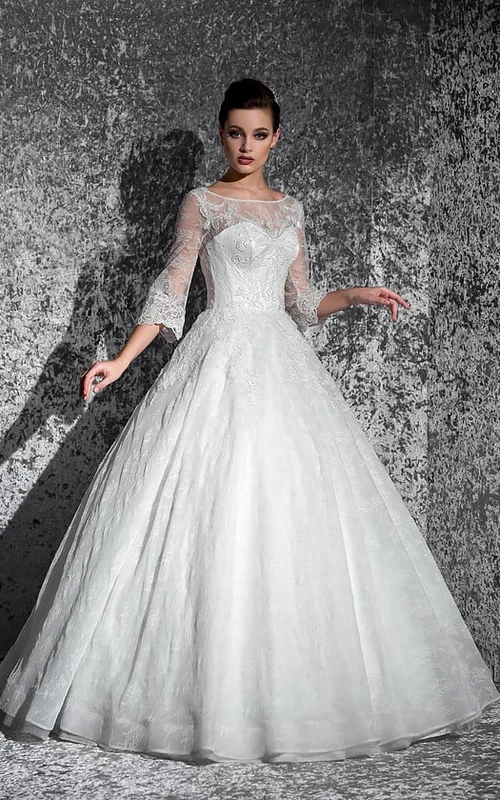 Vestido largo de gala con escote barco, mangas abullonadas, encaje ilusión y apliques.