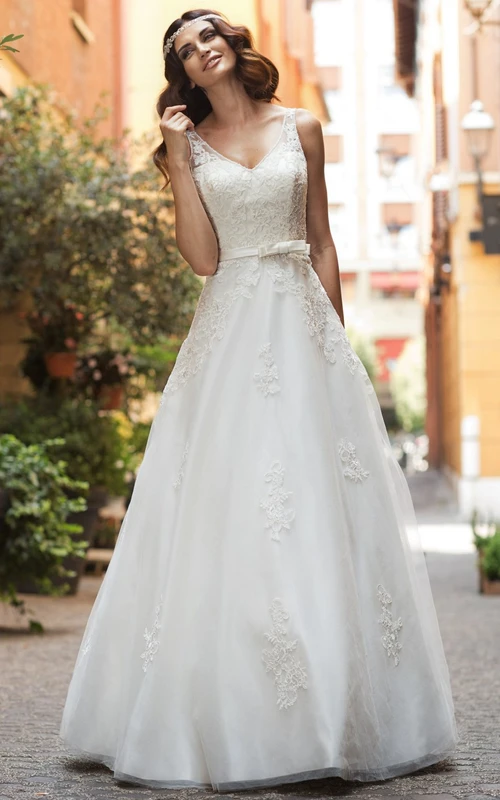 Robe de mariée longue en dentelle et satin, coupe trapèze, col en V, sans manches, ornée d'appliqués