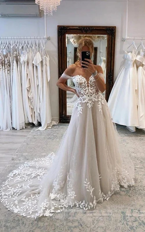 Robe de mariée élégante en tulle, épaules dénudées, coupe trapèze et traîne courte
