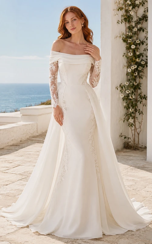 Robe de mariée asymétrique en satin et dentelle poli, épaules dénudées, manches simples, coupe trapèze, traîne et fermeture éclair au dos.