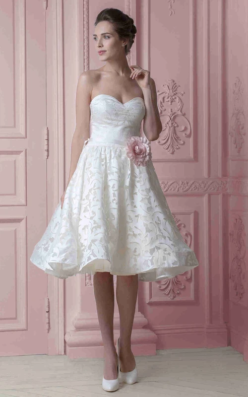 Robe de mariée en satin fleuri, décolleté en cœur, longueur genou, avec ruban et dos corset.