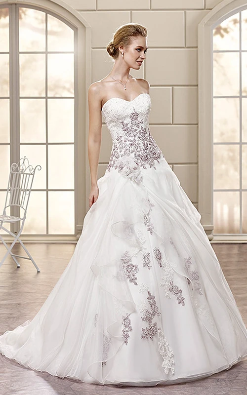 Robe de mariée en organza longue jusqu'au sol, coupe trapèze, décolleté en cœur, ornée d'appliques et de drapés