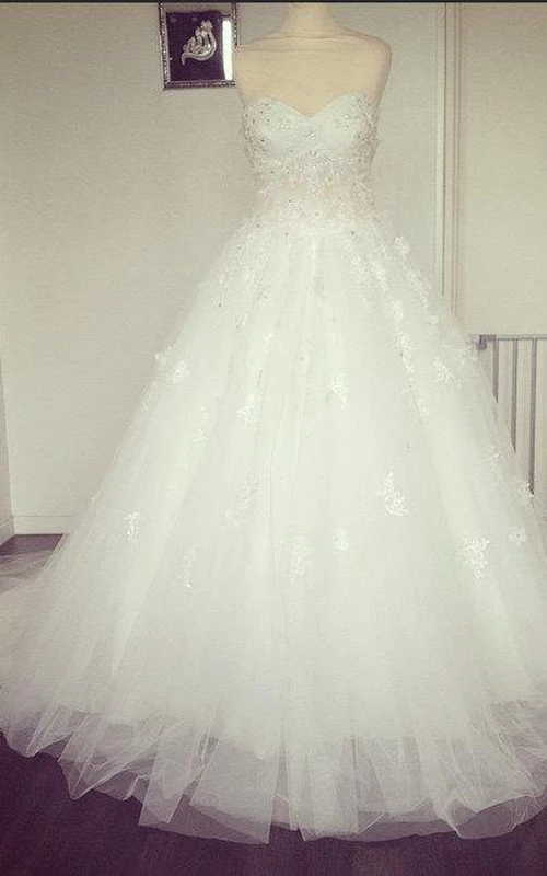 Vestido de gala de tul con escote corazón, corpiño de encaje y abalorios.