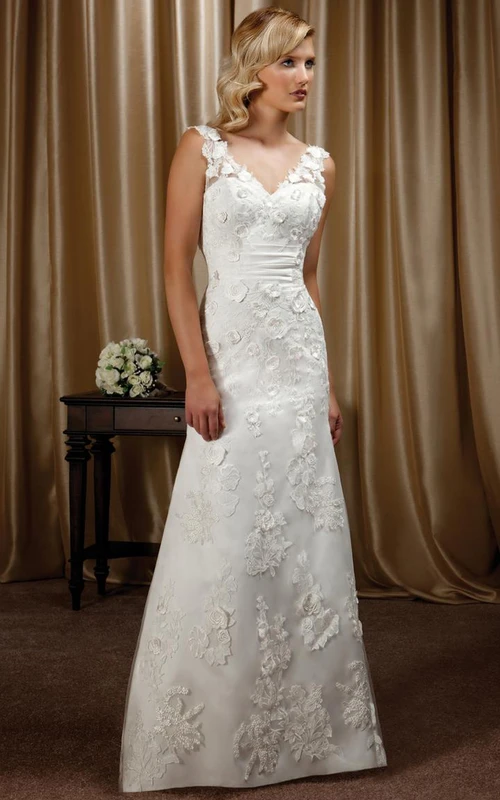 Vestido de novia largo hasta el suelo con escote en V, sin mangas, con apliques florales y espalda con escote en V profundo.