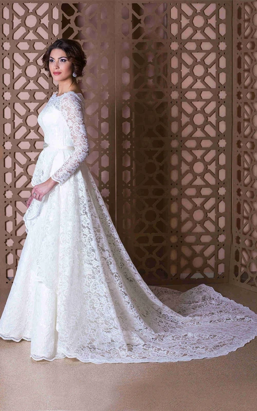 Robe de mariée longue en dentelle à manches longues et décolleté rond, ornée d'un nœud.