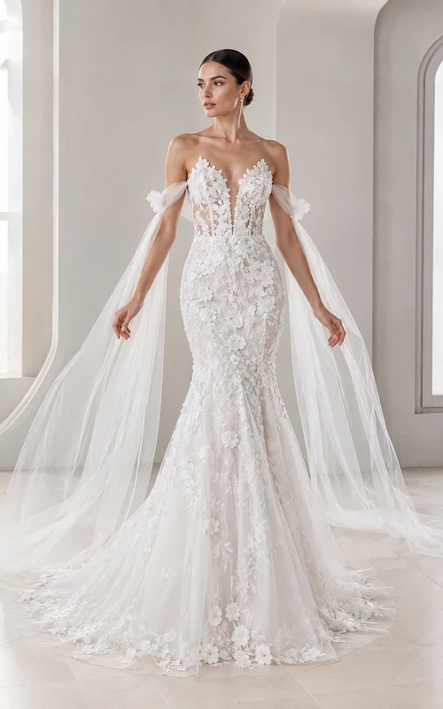 Vestido de novia de encaje estilo sirena con escote Bardot y capa.