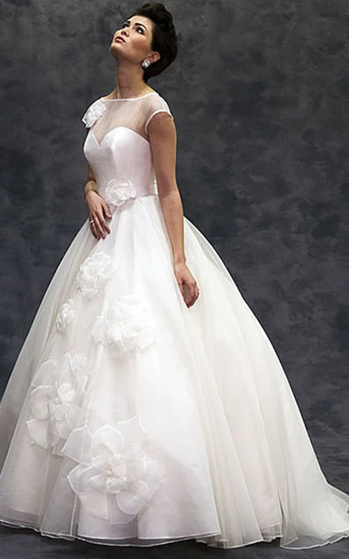 Vestido de novia de tul largo hasta el suelo, de manga corta y escote barco, con flores y detalles de ilusión.