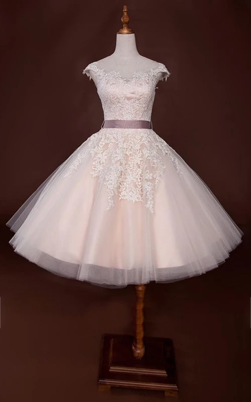 Robe courte à cloche ornée de perles et d'appliques, fermeture éclair et laçage au dos, en mousseline, tulle, dentelle, sequins, organza, satin et taffetas.