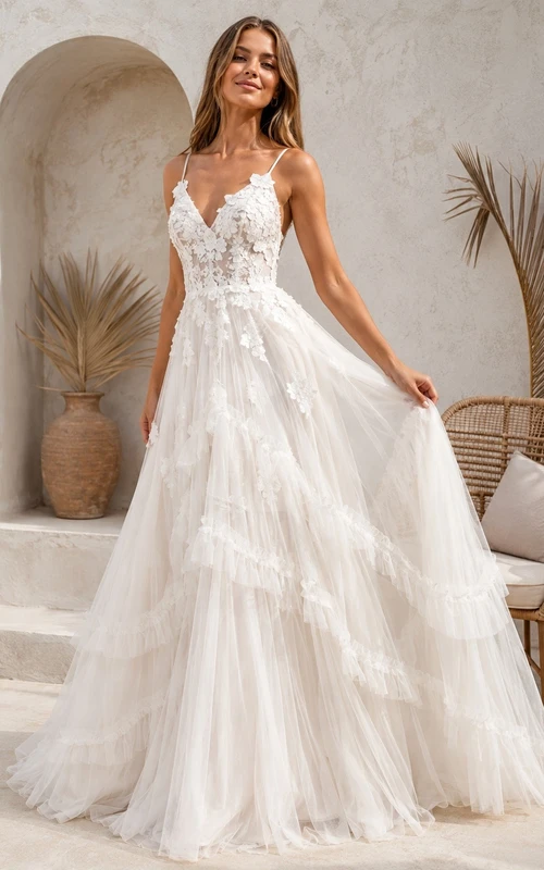 Vestido de gala blanco de tul con escote corazón, sin mangas, largo hasta el suelo, con volantes escalonados.