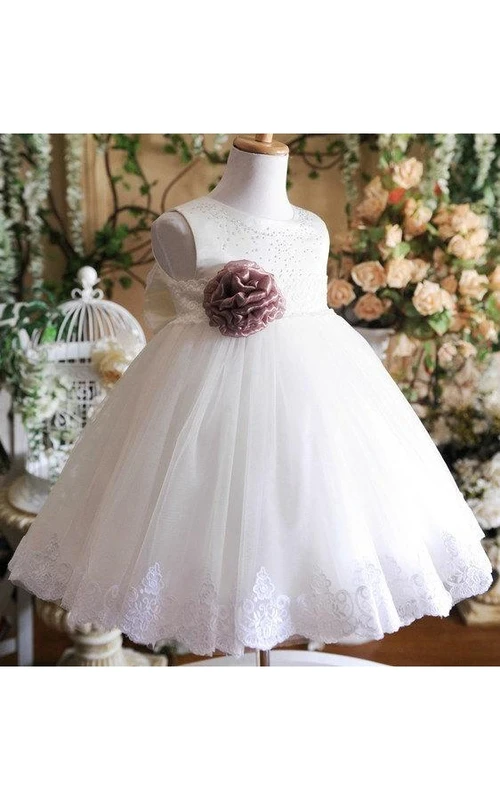 Robe trapèze sans manches en tulle, col rond, longueur genou, ornée d'un nœud et d'appliqués. Coupe trapèze, col rond, sans manches. Ornée d'un nœud et d'appliqués.