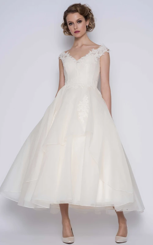 Elegante vestido de novia de organza de gala con mangas cortas y largo hasta los tobillos con flores.