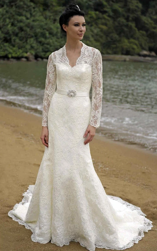 Robe de mariée fourreau en dentelle à manches longues et col en V ornée d'appliqués et d'une broche
