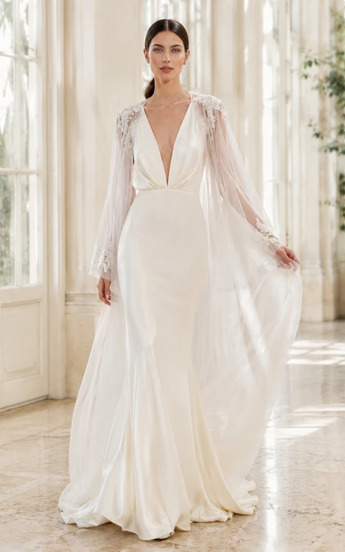 Robe de mariée de soirée en mousseline polie, décolleté en V profond, manches cape, coupe trapèze et traîne chapelle